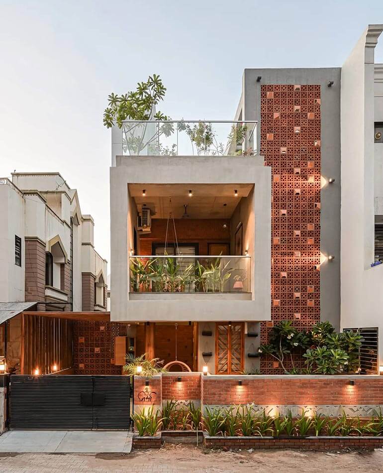 The vertical brick jaali runs from the top to the bottom letting natural light in concealing ducts and providing privacy...